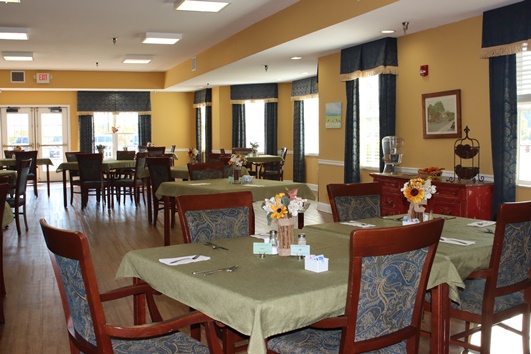 Bright dining room with tables set for meals