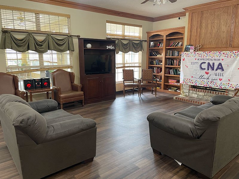 Bright common area with seating and bookshelves