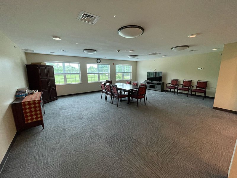 Well-lit interior common area with seating and windows