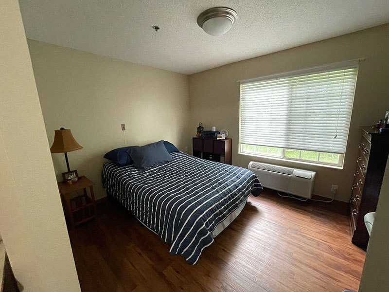 Cozy private resident room with wooden flooring