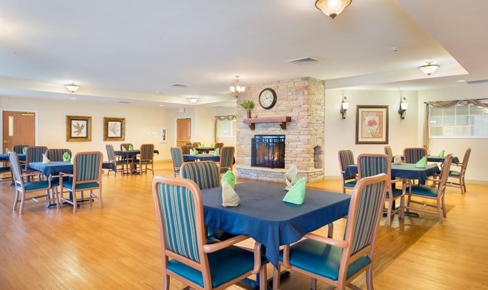 Brightly lit dining room with tables and chairs