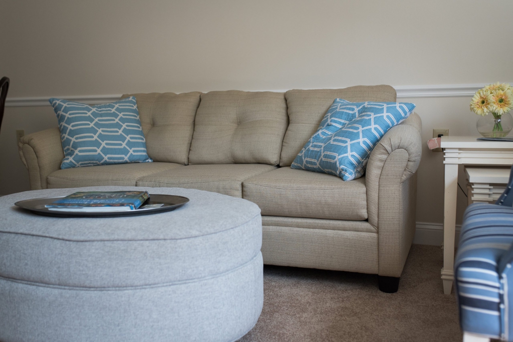 Cozy living room with beige couch and blue pillows