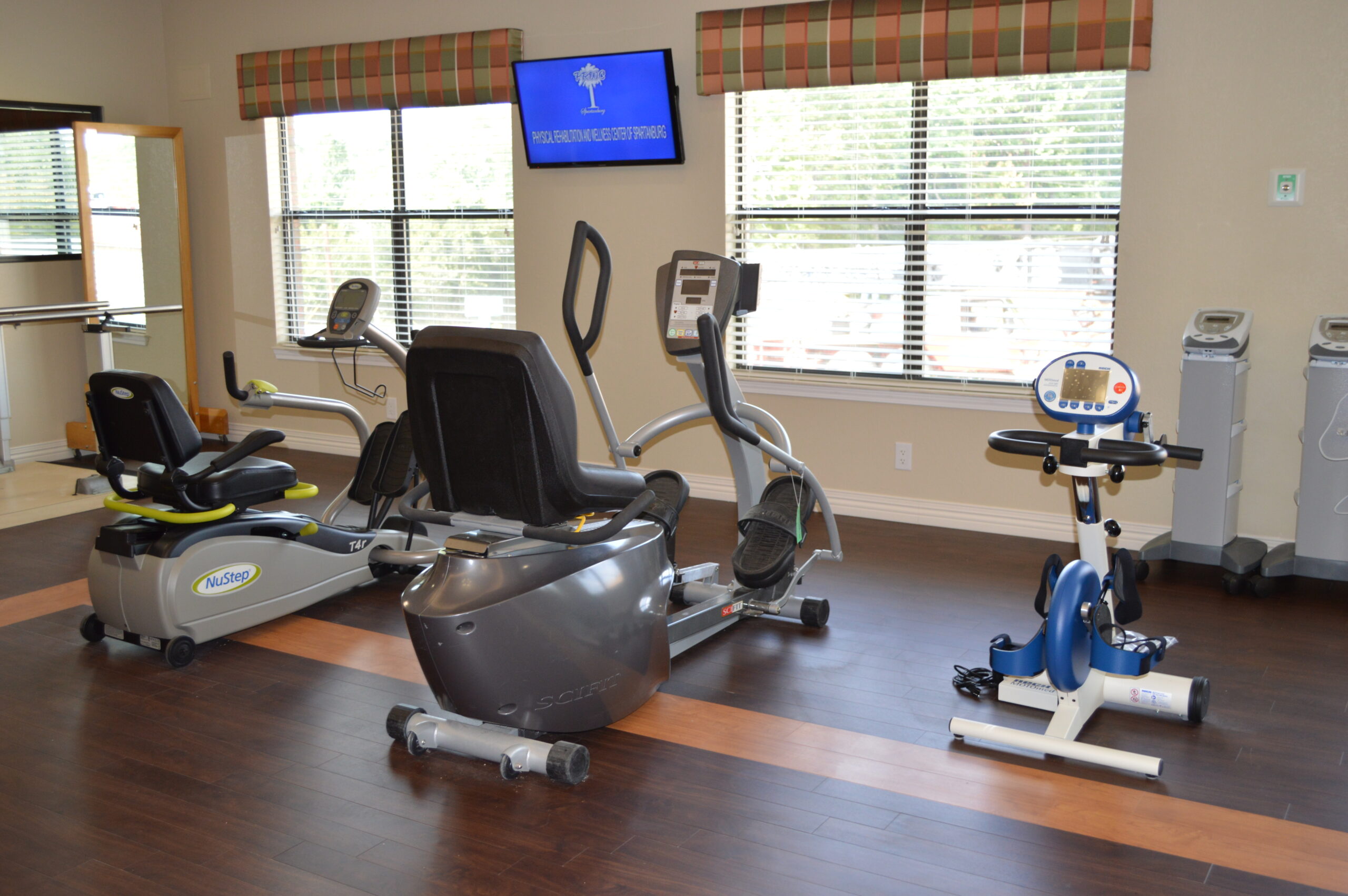 Facility gym equipment in a well-lit room
