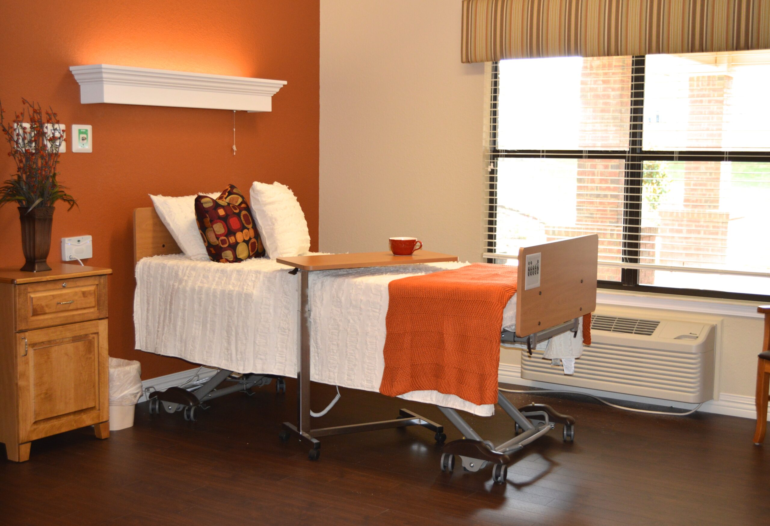 Interior view of a resident room with a hospital bed