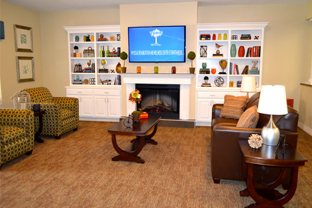 Cozy common area with chairs and a fireplace
