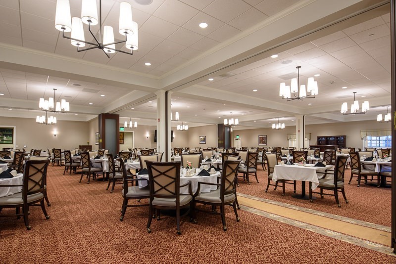 Bright dining room with tables set for meals