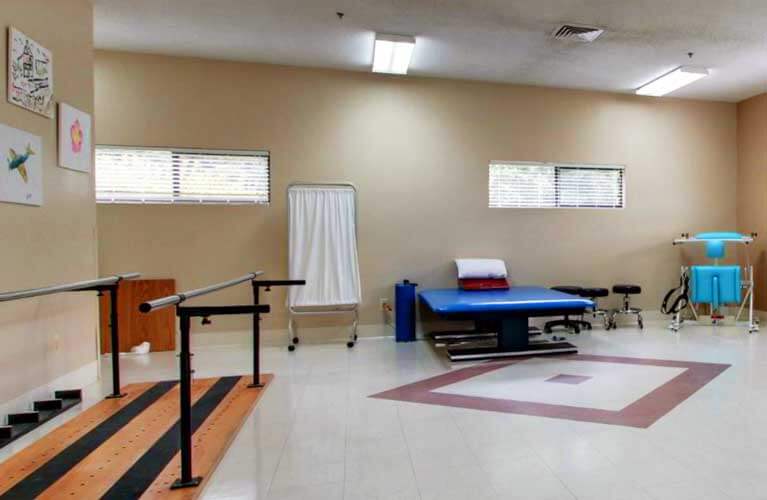 Therapy room with rehabilitation equipment and natural light