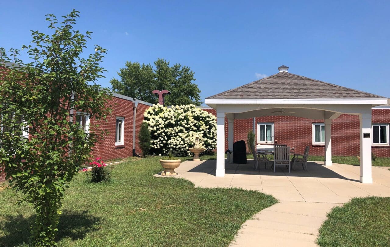 Outdoor gazebo area with seating and landscaping