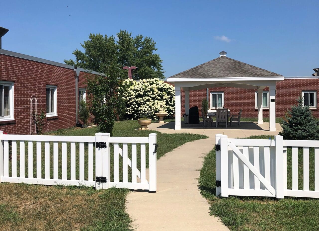 Exterior view of a senior care facility with garden space