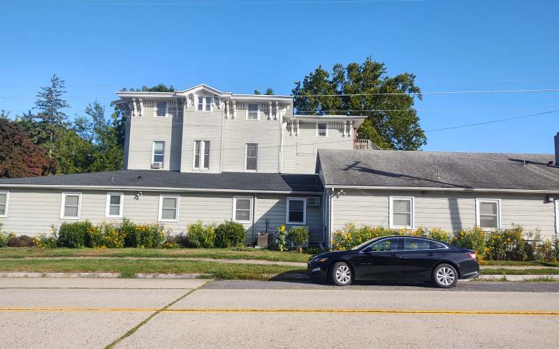 Exterior view of Clover Rest Home with garden