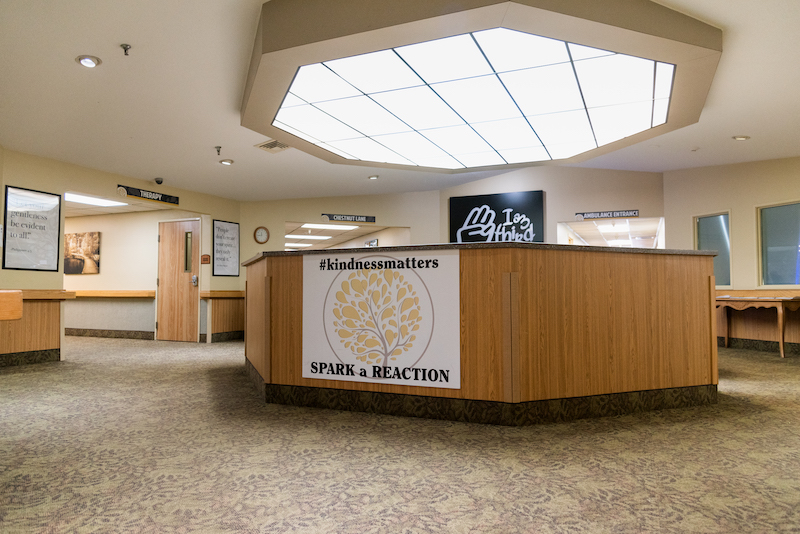 Interior view of a welcoming common area with a sign