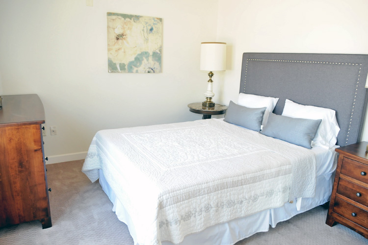 Cozy bedroom with a double bed and art decor
