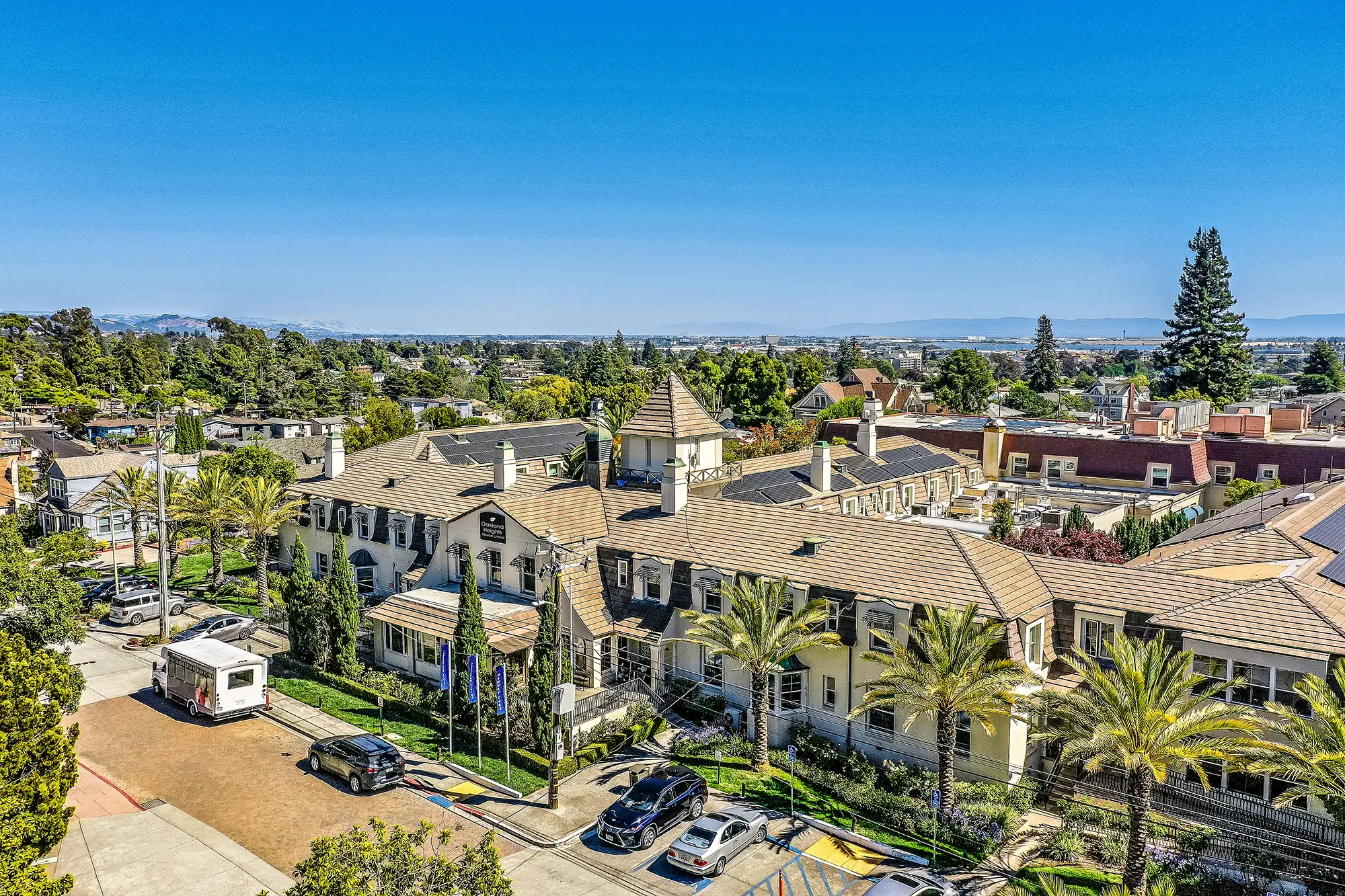 Aerial view of a senior living facility with palm trees