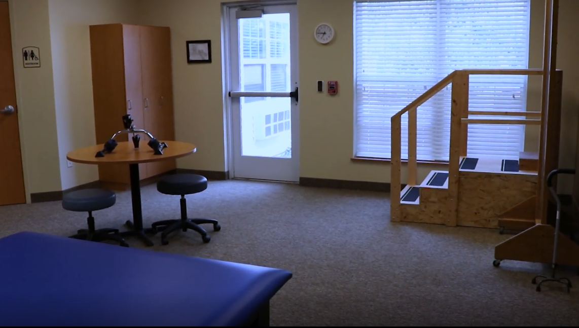 A well-lit therapy room with equipment and furniture