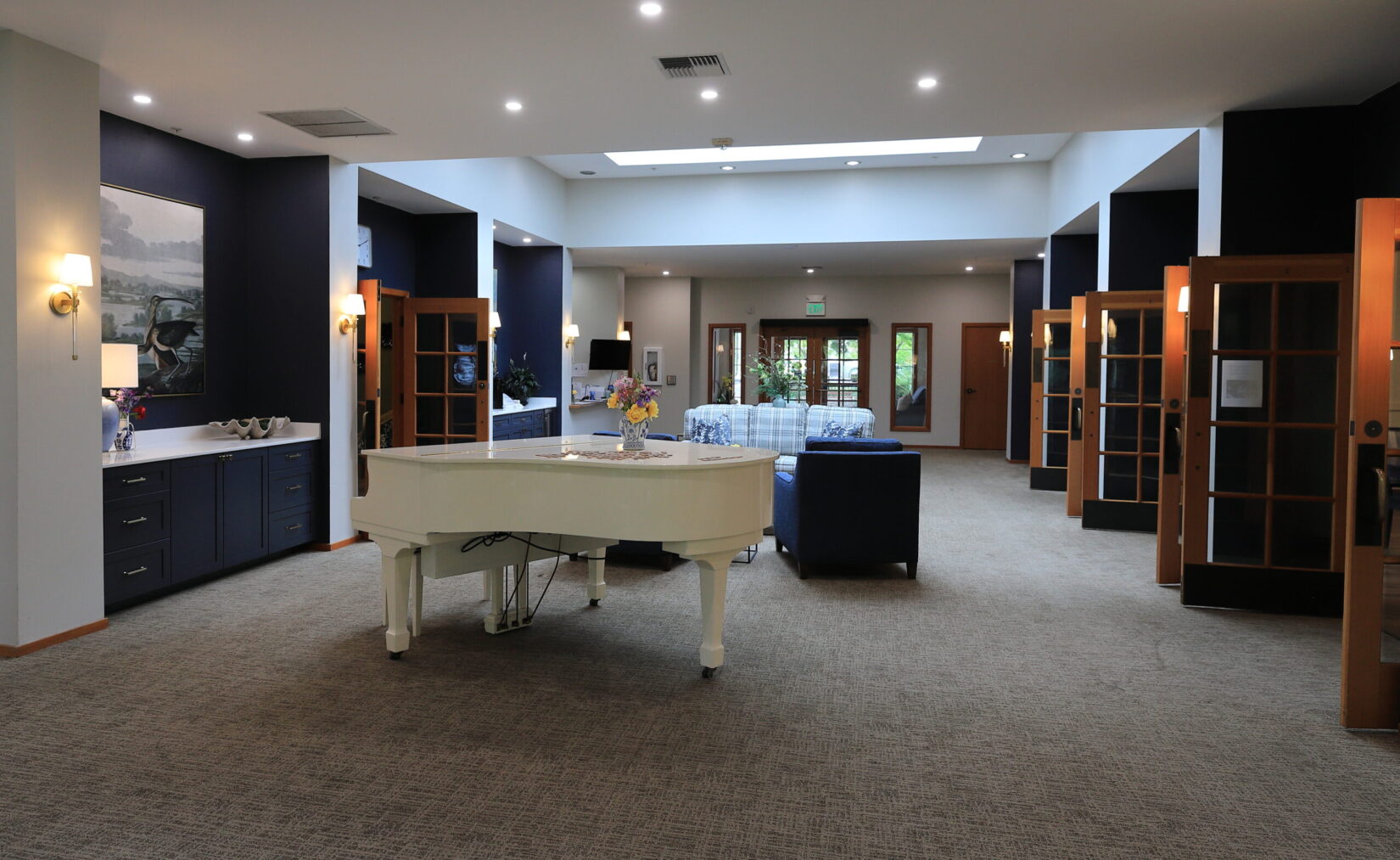 Bright common area with piano and seating