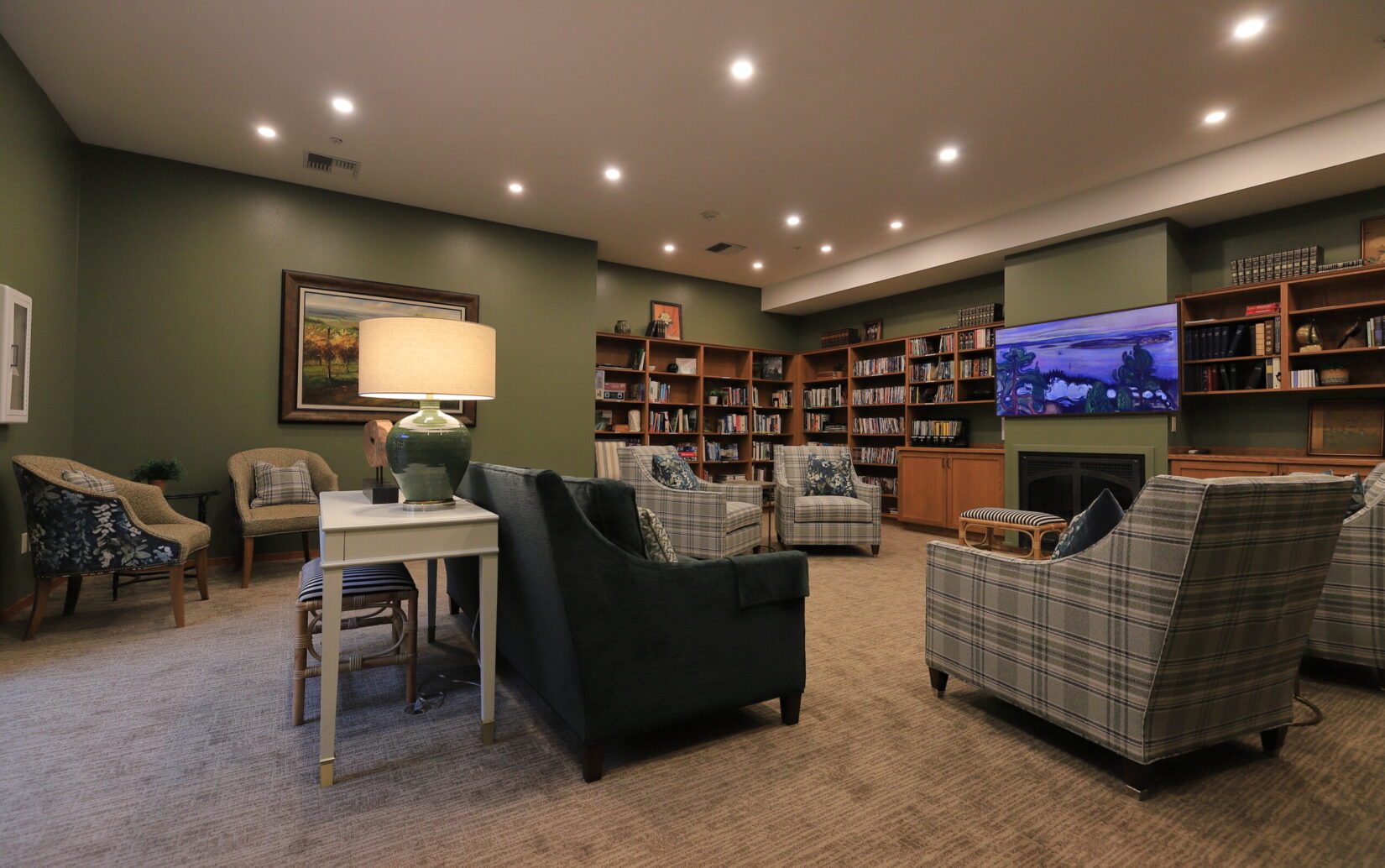 A cozy common area with seating and bookshelves