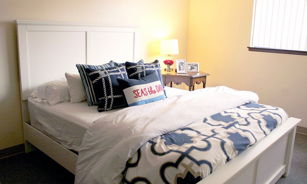 Cozy resident room with a bed and decorative pillows