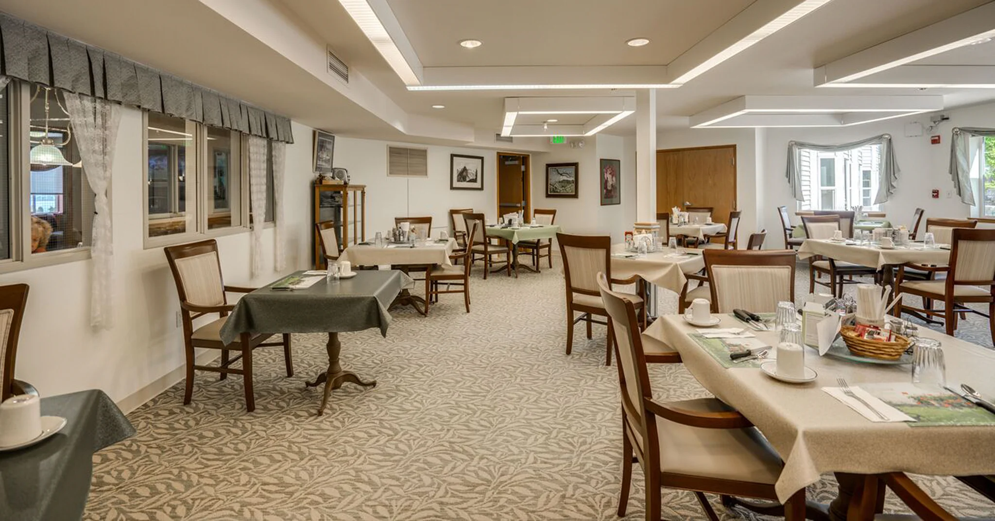 Bright dining room with tables set for a meal