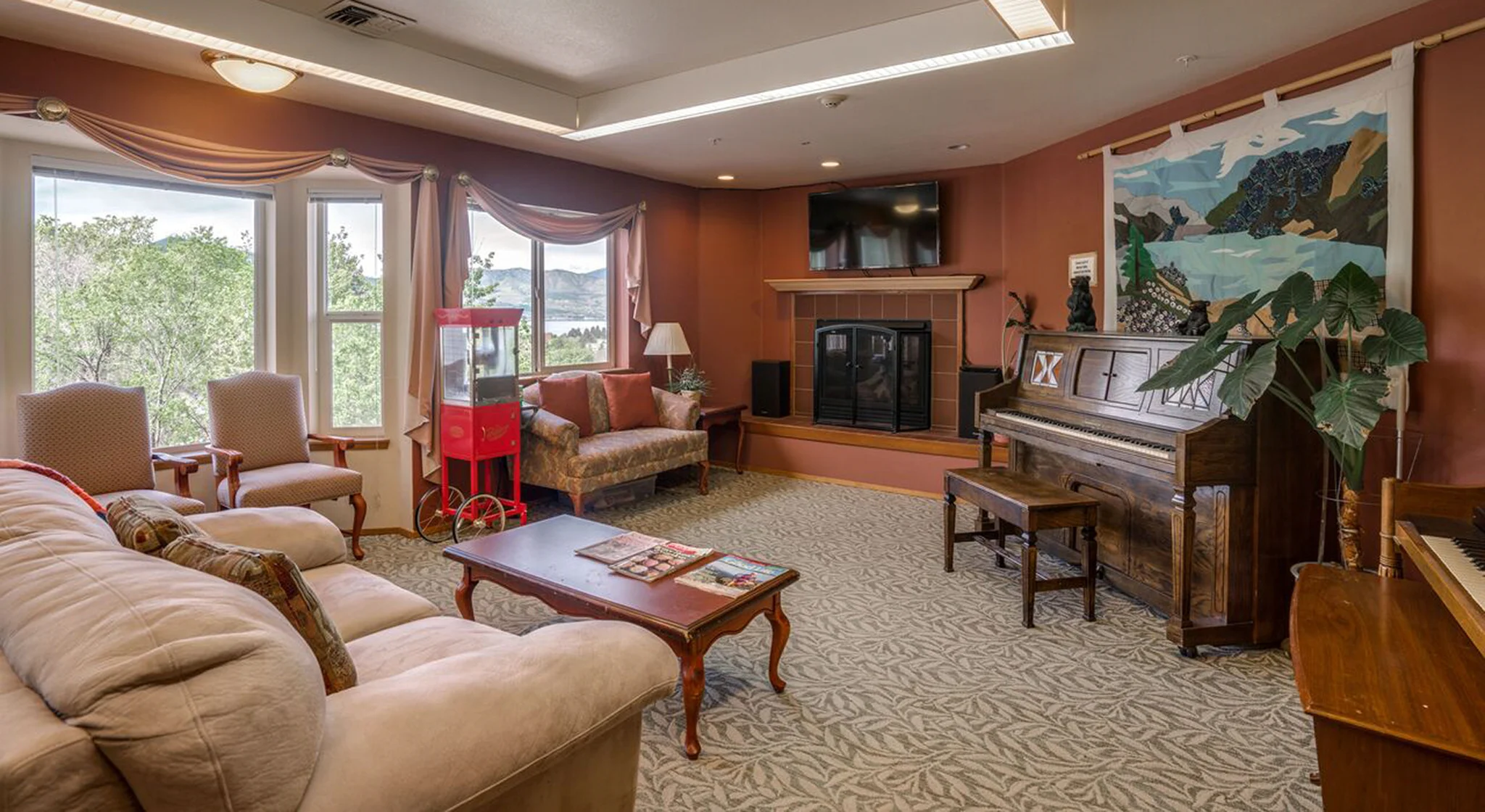 Bright common area with seating and a piano