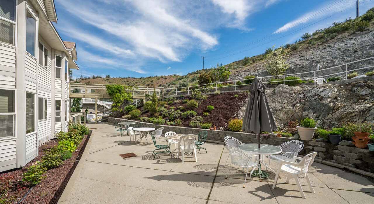 Outdoor patio area with seating and landscaping