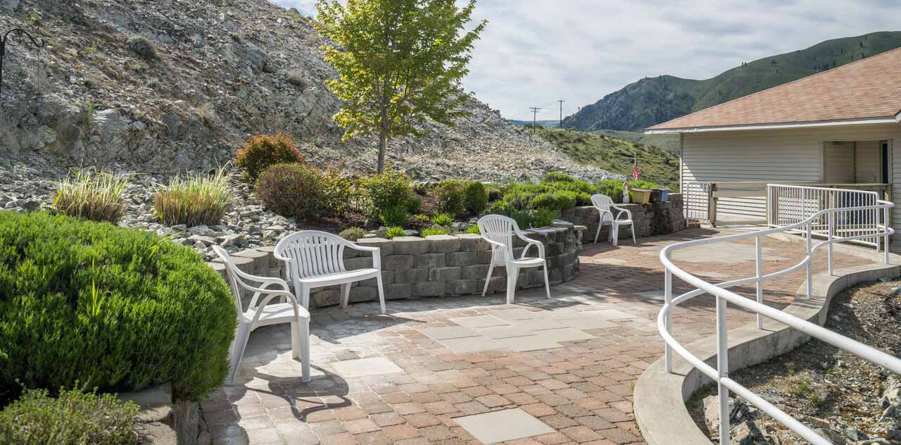 Outdoor seating area with chairs and landscaping
