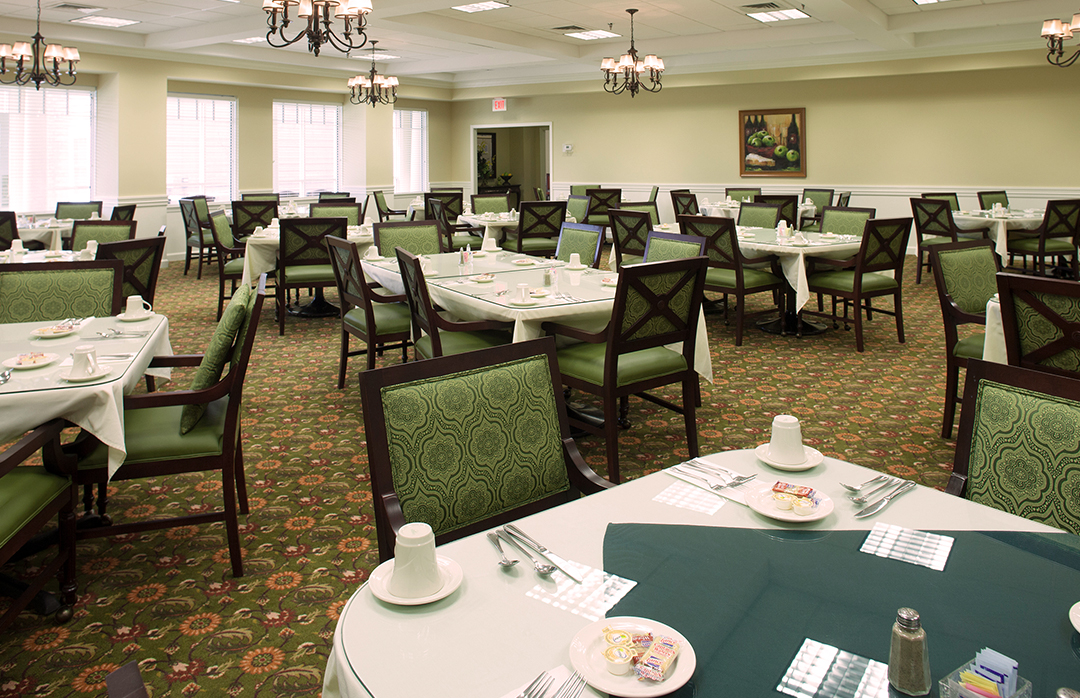 Dining room with tables set for residents