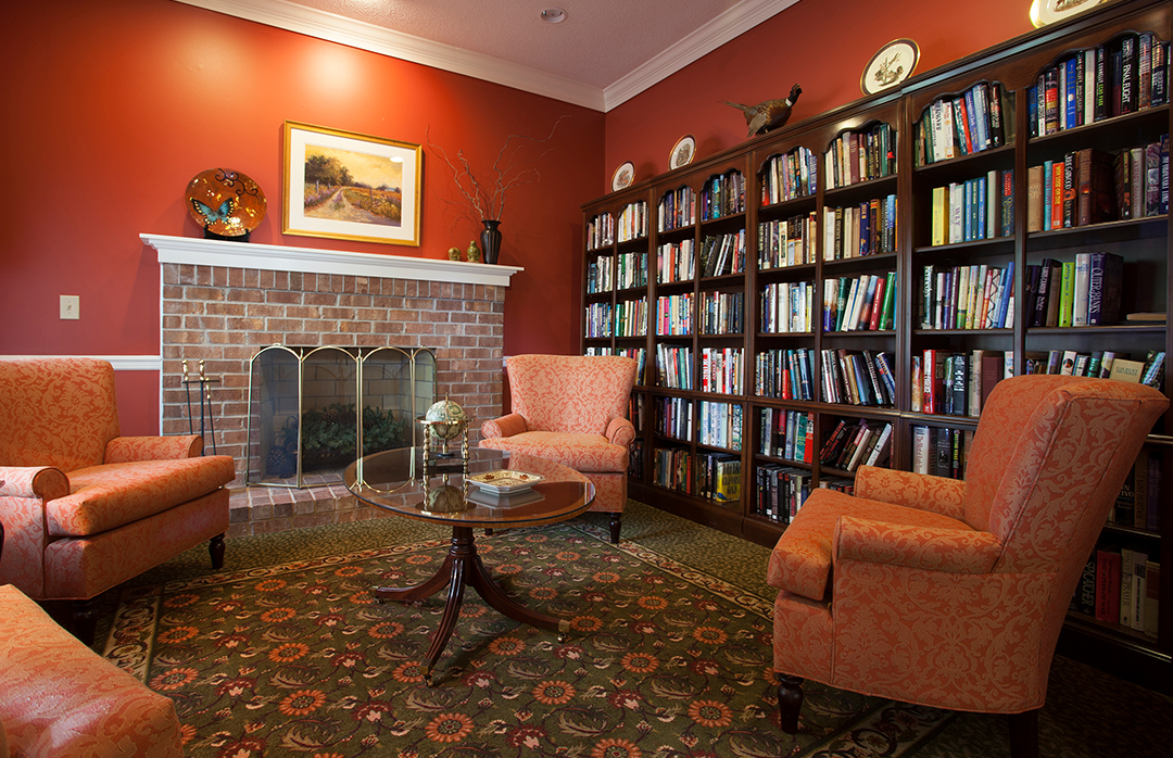 Cozy common area with bookshelves and armchairs