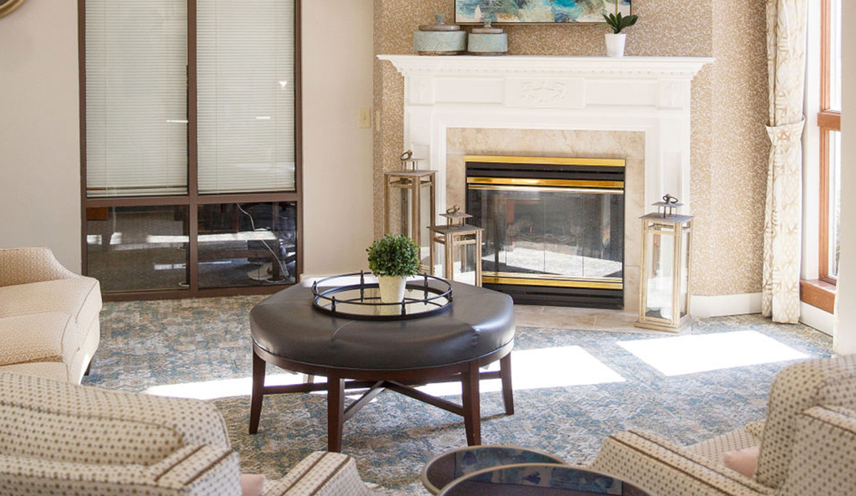Comfortable seating area with a fireplace in a common lounge