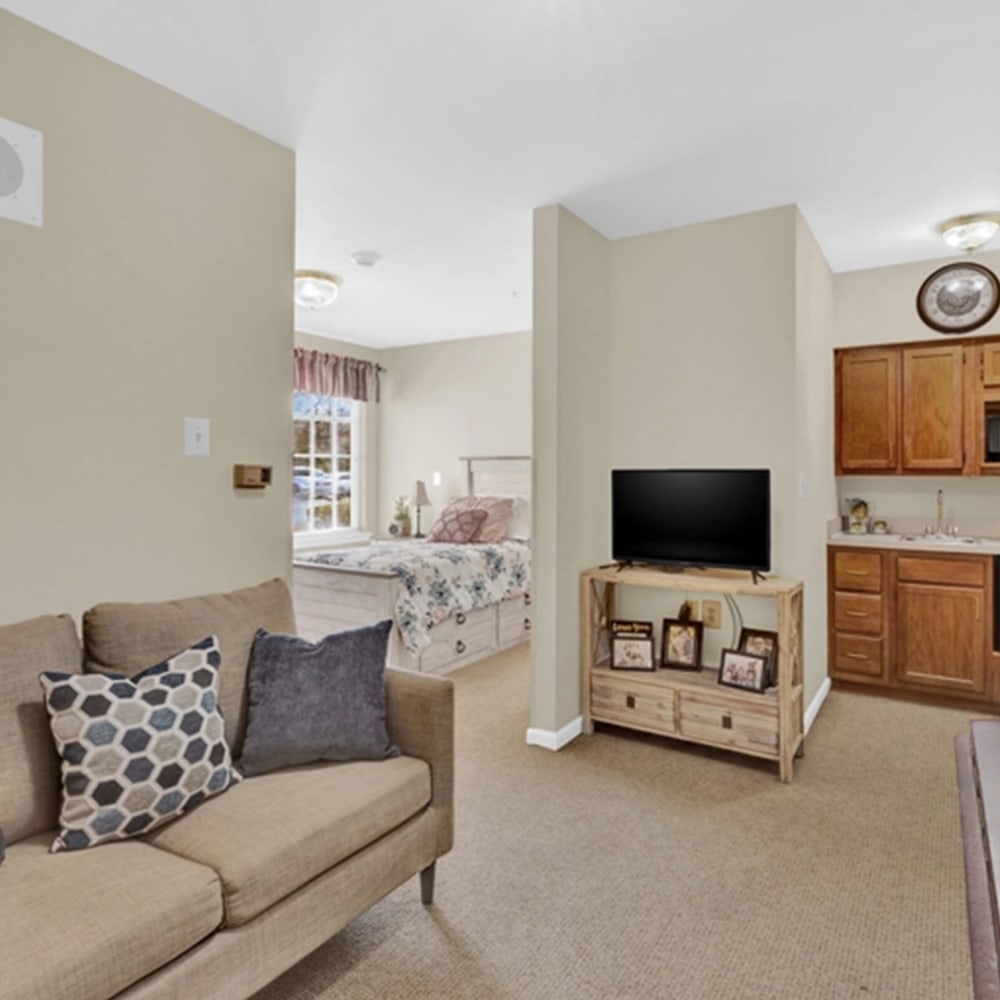 Cozy studio apartment with seating area and kitchenette