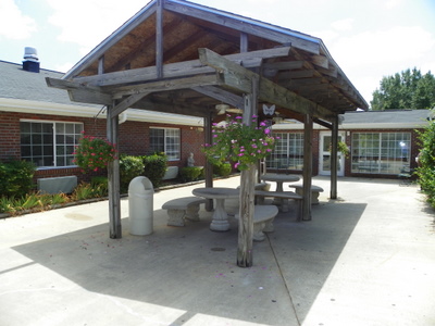 Outdoor covered seating area with picnic tables