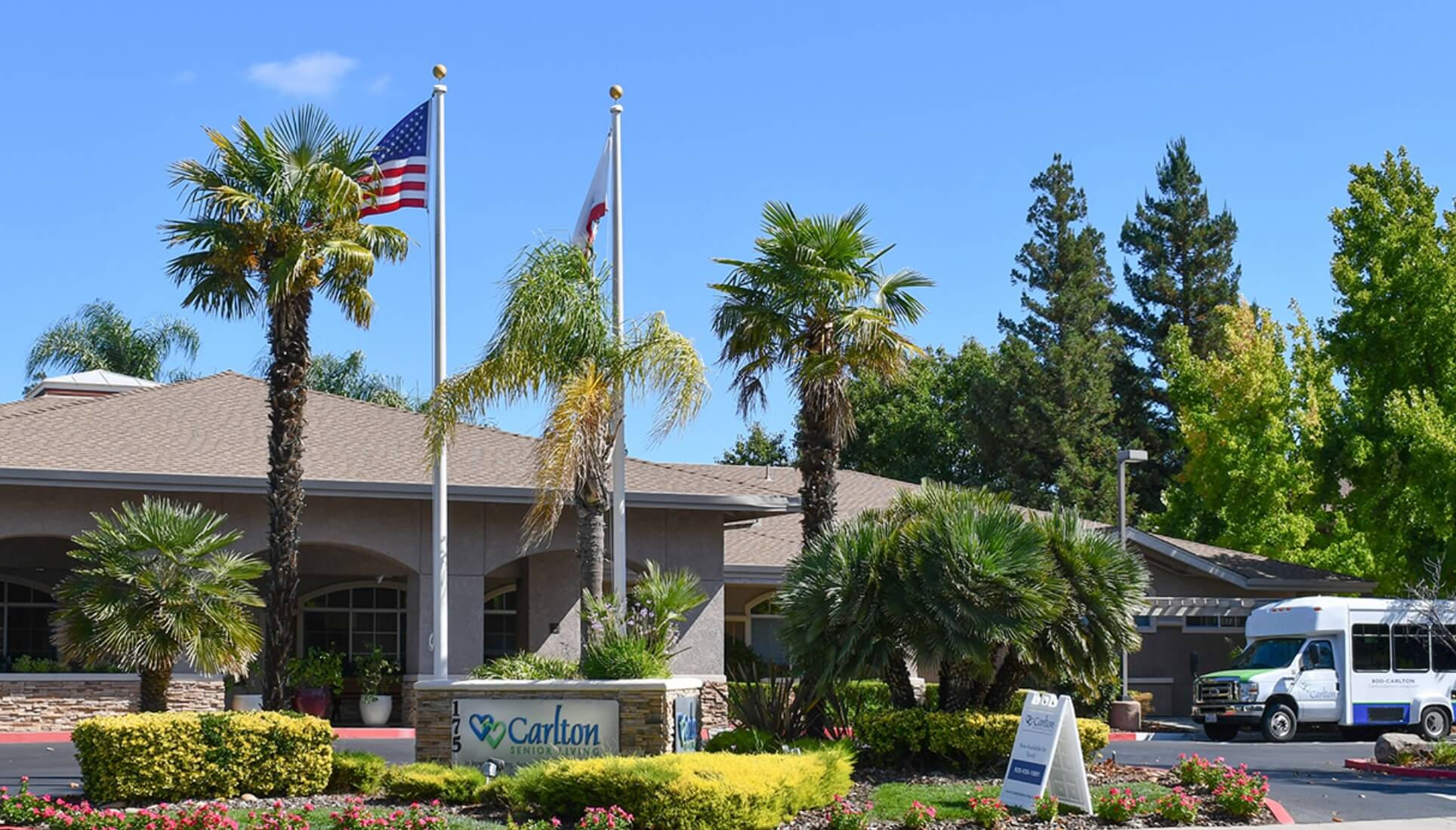 Exterior view of a senior living facility with landscaping