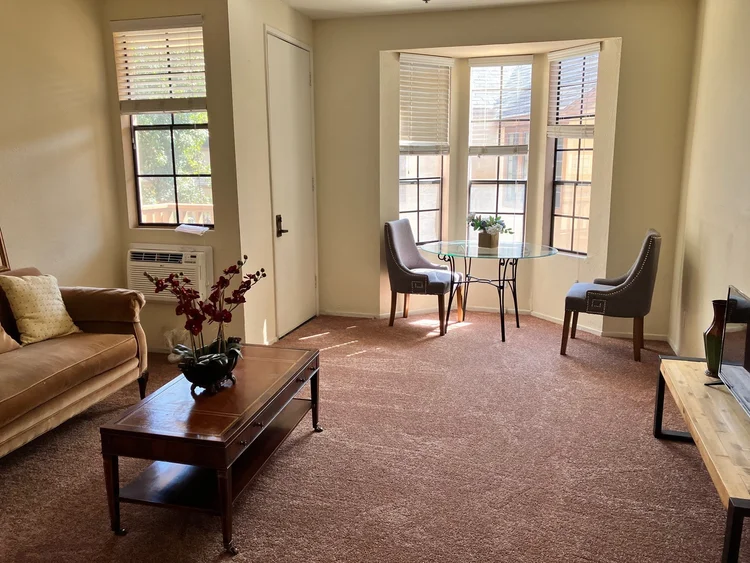 Bright interior of a resident room with seating area