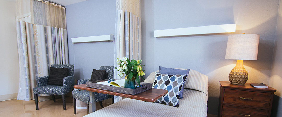 Comfortable resident room with natural light and decor