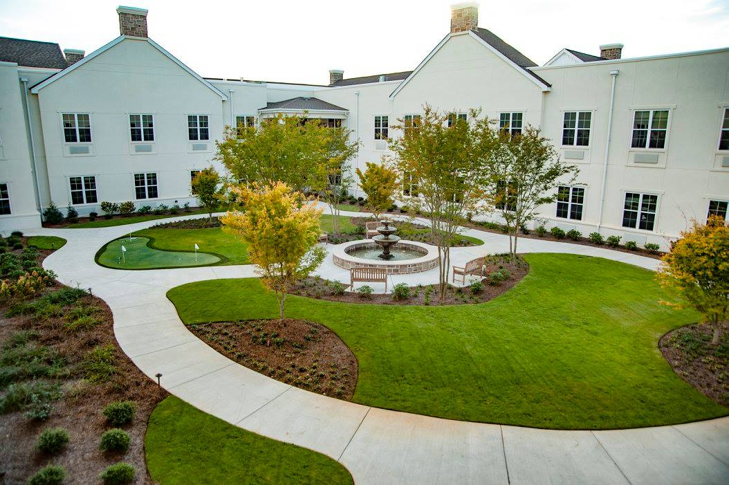 Serene landscaped courtyard with fountain and walking paths