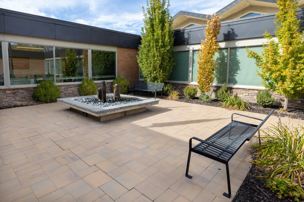 Outdoor patio area with seating and fountain.