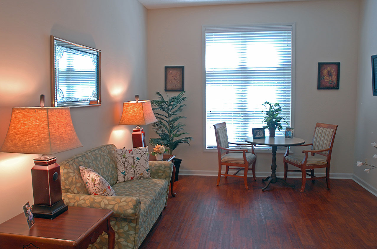 Bright common area with a sofa and dining table