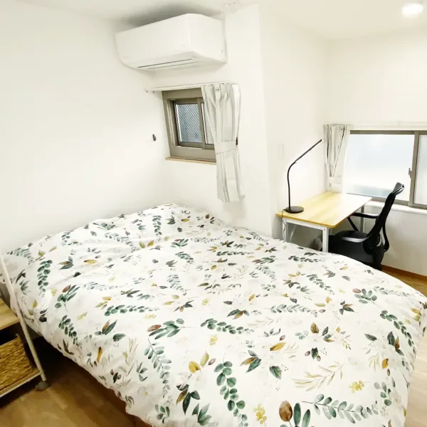 Cozy resident room with bedding and workspace