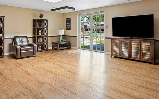 Common area with seating and large TV