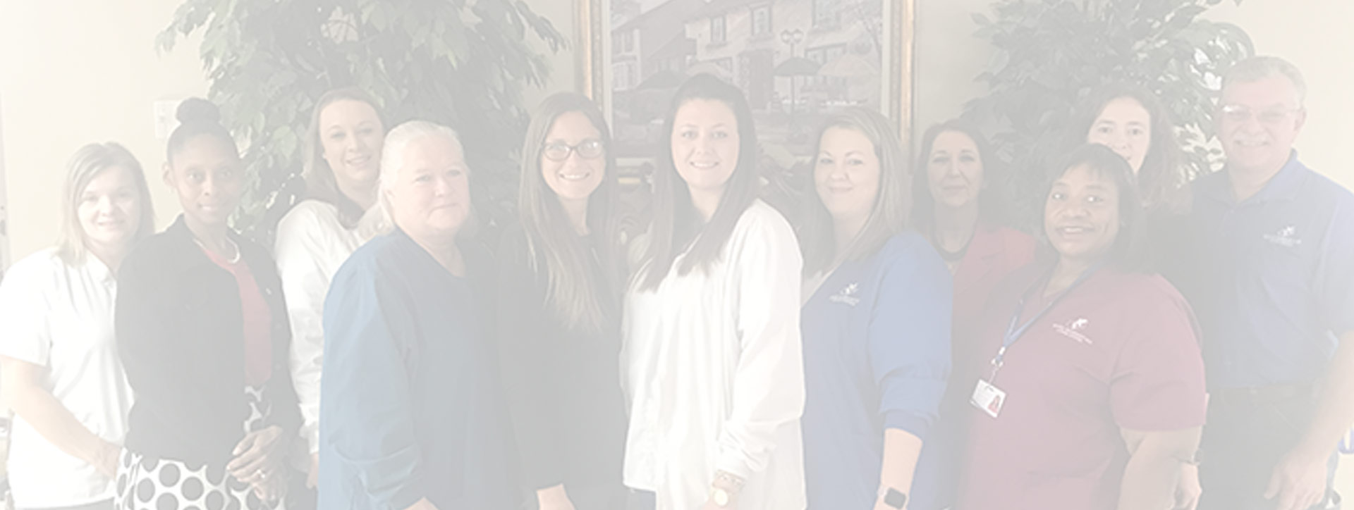 Staff members posing together in a common area