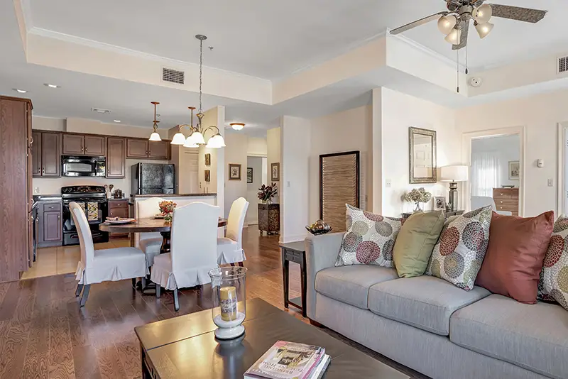 Interior view of a senior living apartment with a living room and kitchen