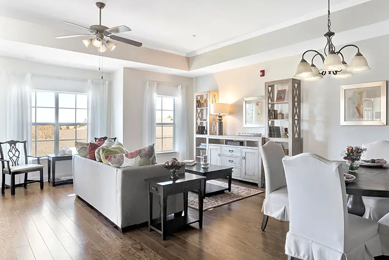Bright common area with comfortable seating and dining