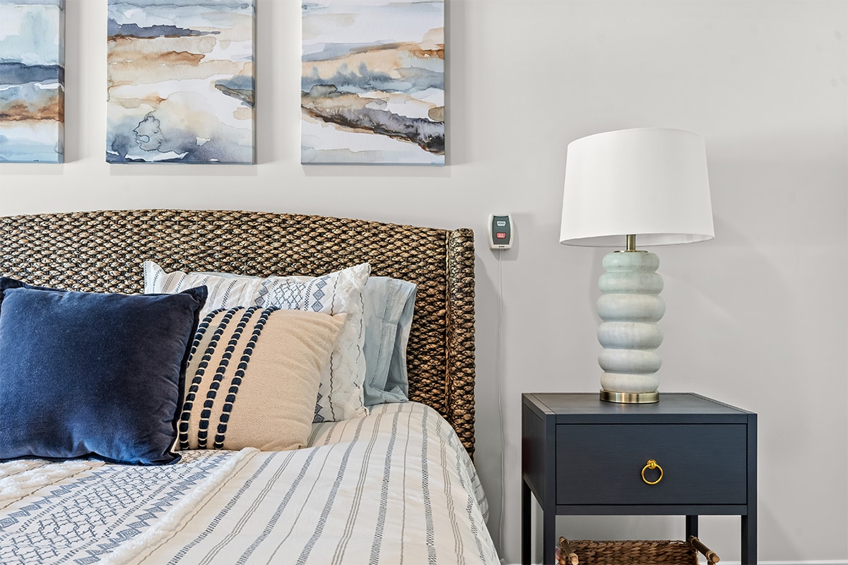 Stylish bedroom with decorative art and lamp