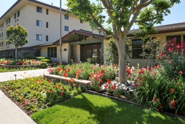 Beautiful garden with colorful flowers in front of the facility.
