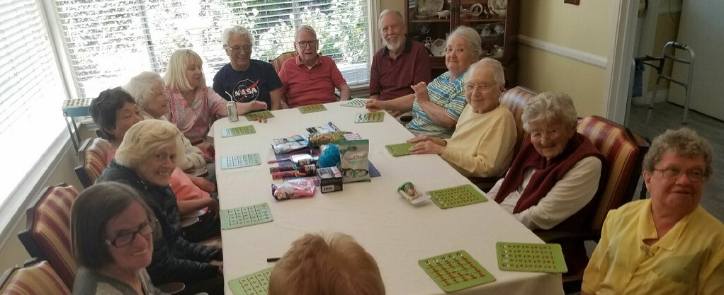 Residents enjoying a bingo activity in a common area.