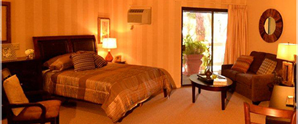 Cozy resident room with a bed and seating area.
