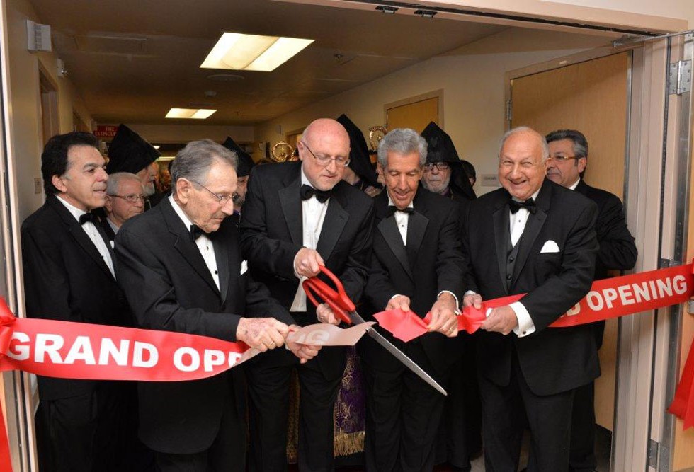 Ribbon-cutting ceremony for a grand opening event.
