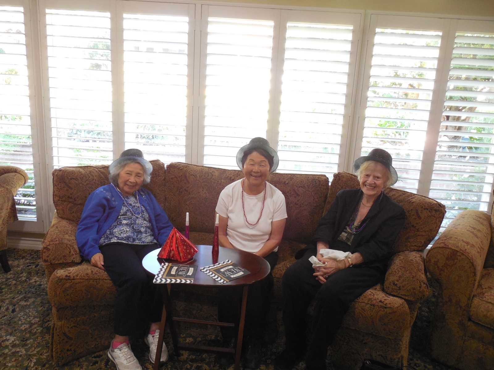 Three residents enjoying a social gathering indoors.