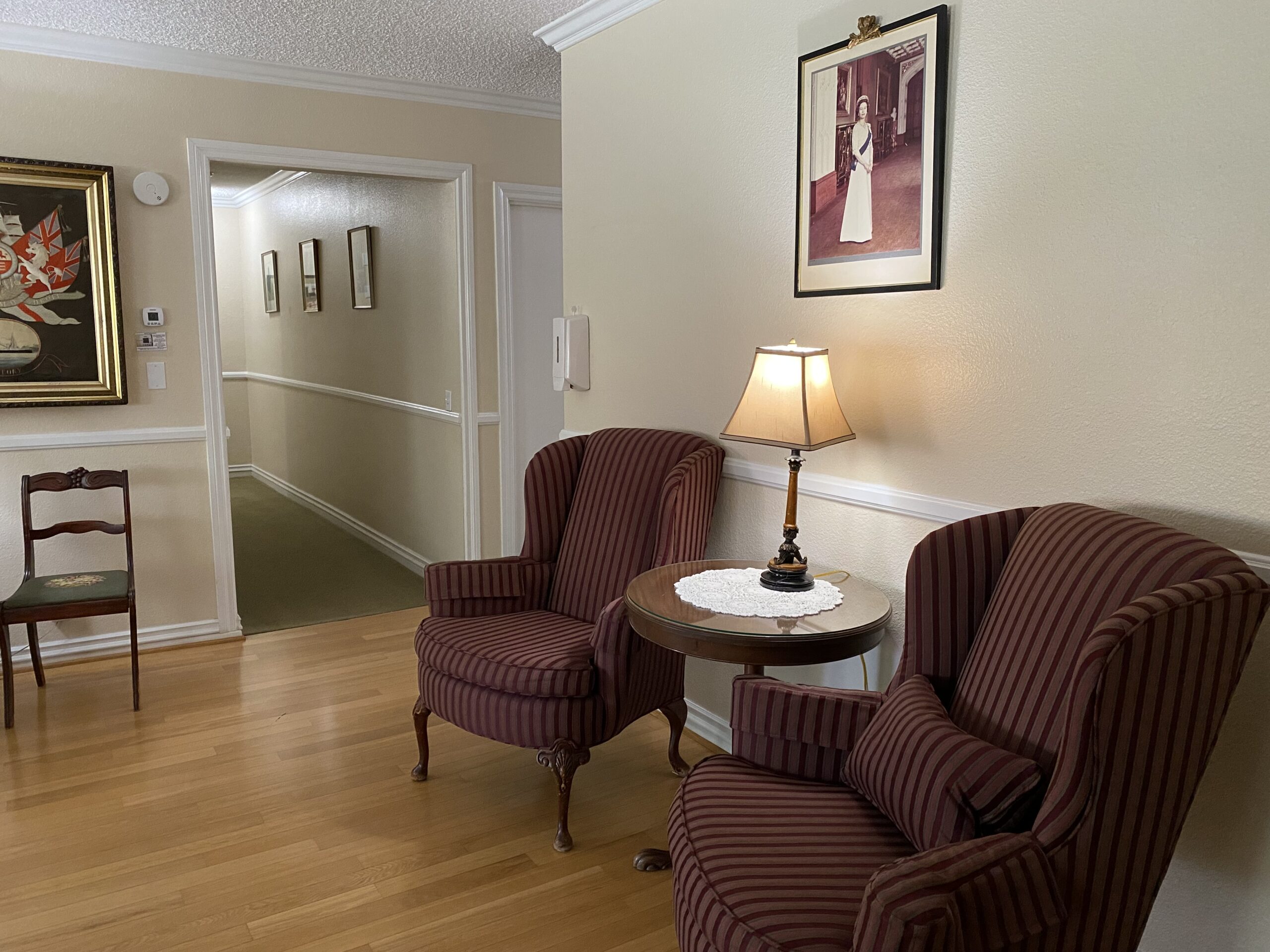 Cozy common area with chairs and artwork.