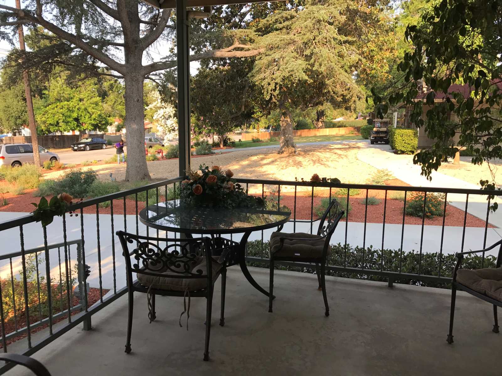Outdoor patio area with a view of gardens.