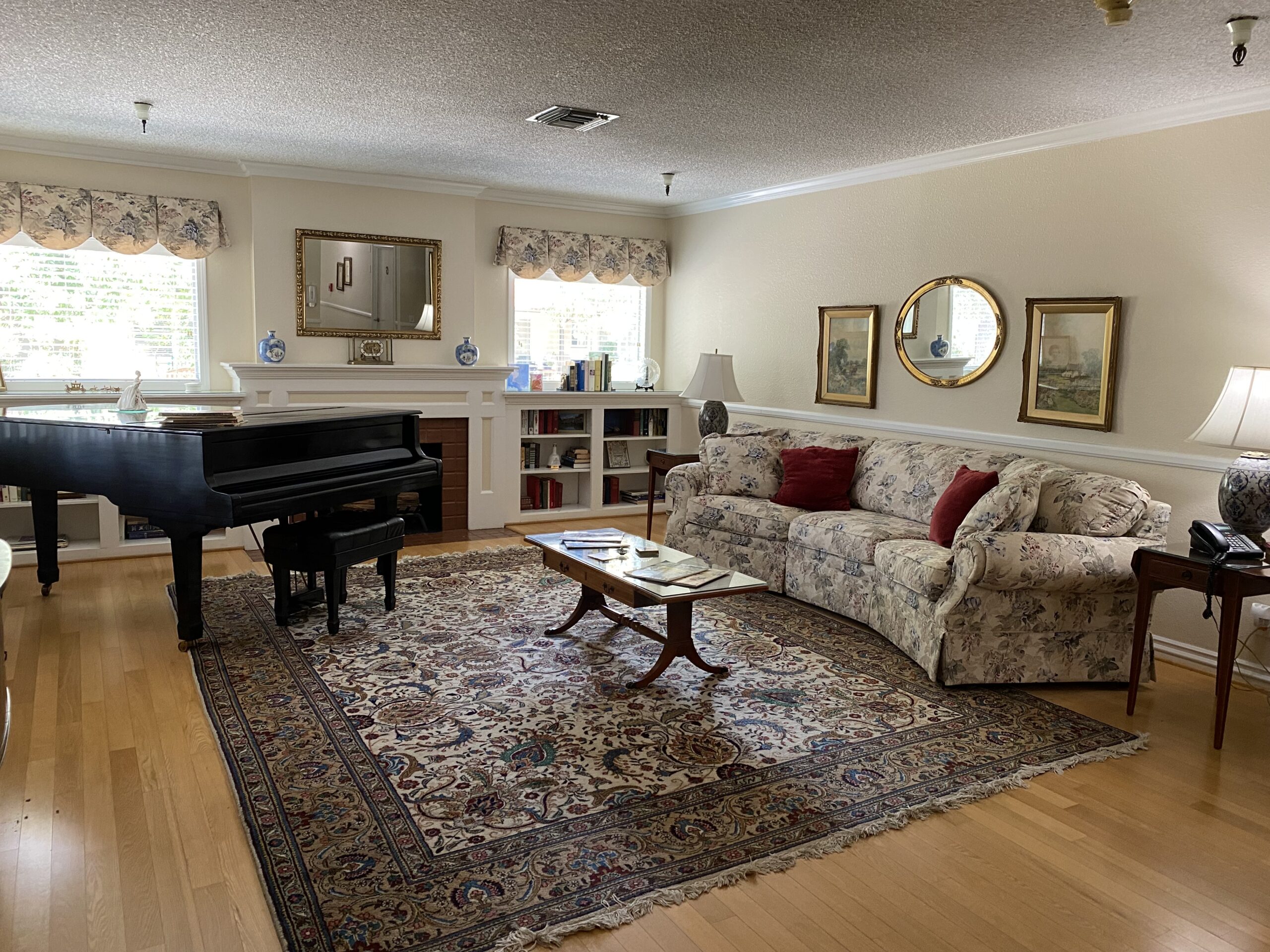 Cozy lounge area with piano and bookshelves